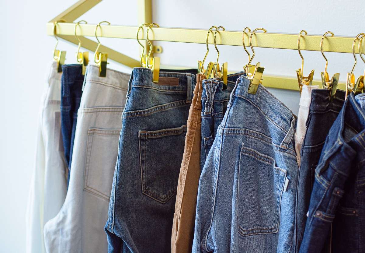 jeans hanging by gold clips
